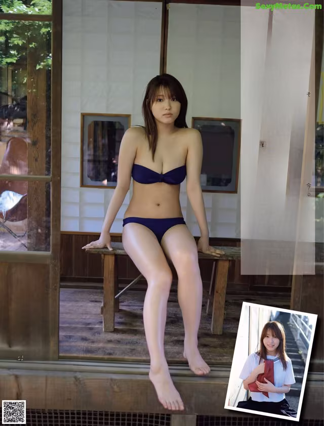 A woman in a blue bikini sitting on a wooden bench.