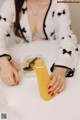 A woman sitting at a table with a glass of orange juice.